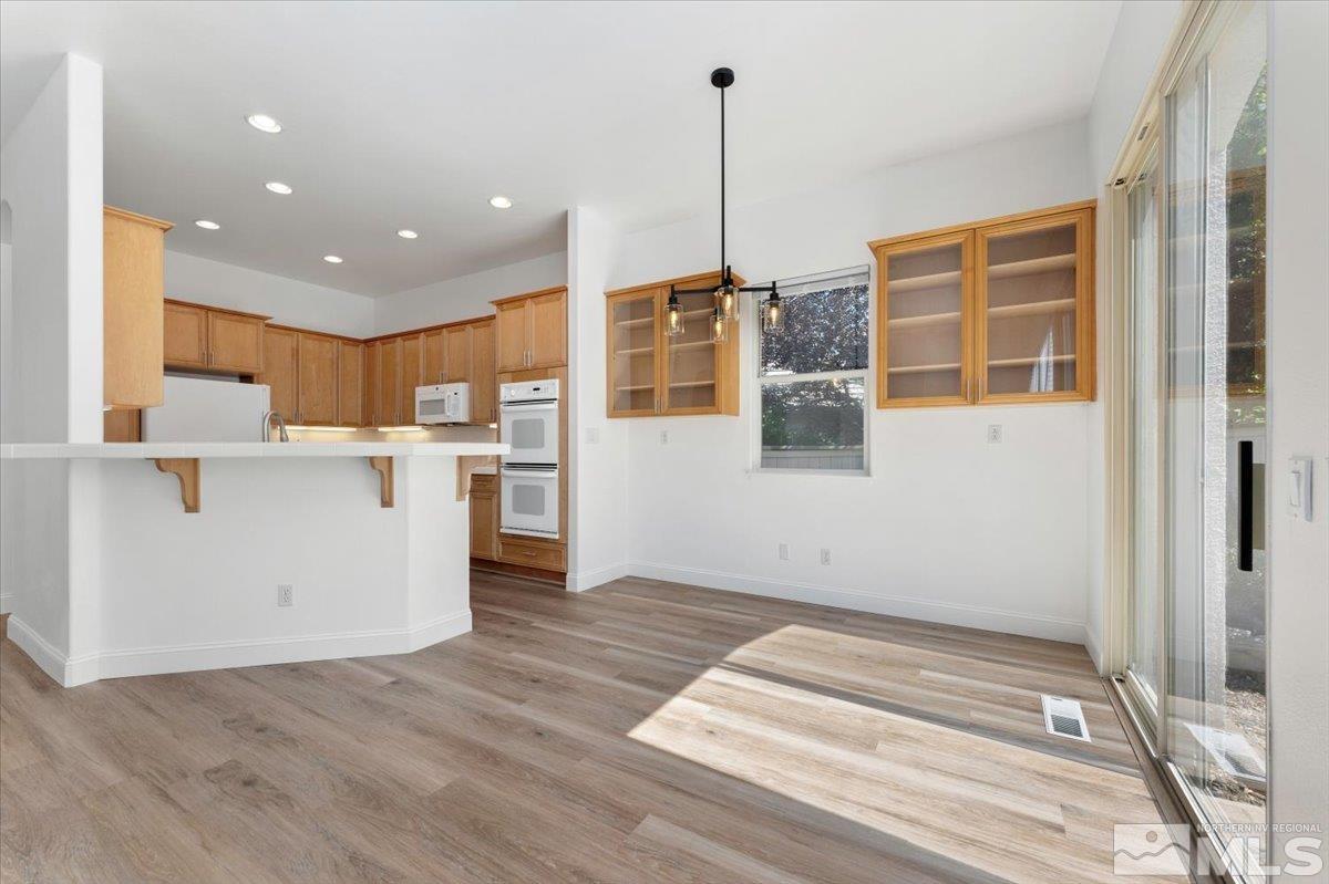 1730 Hunter Creek Road Reno, NV 89519 - Photo 12 of 39 a view of a kitchen with wooden floor and windows