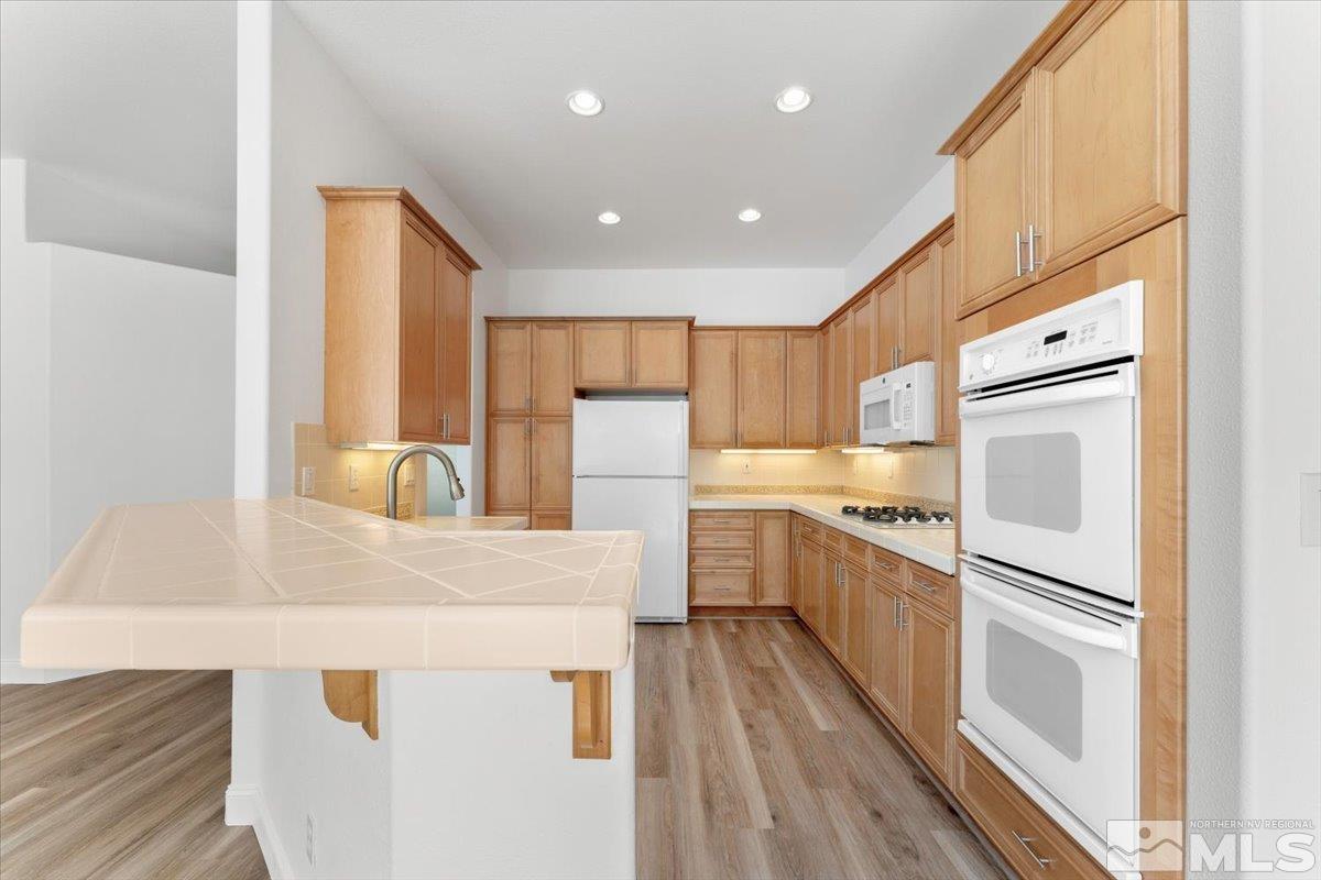 1730 Hunter Creek Road Reno, NV 89519 - Photo 13 of 39 a kitchen with white cabinets and stainless steel appliances
