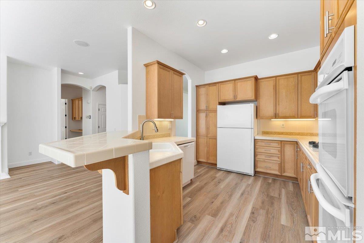 1730 Hunter Creek Road Reno, NV 89519 - Photo 14 of 39 a kitchen with a sink stove and refrigerator