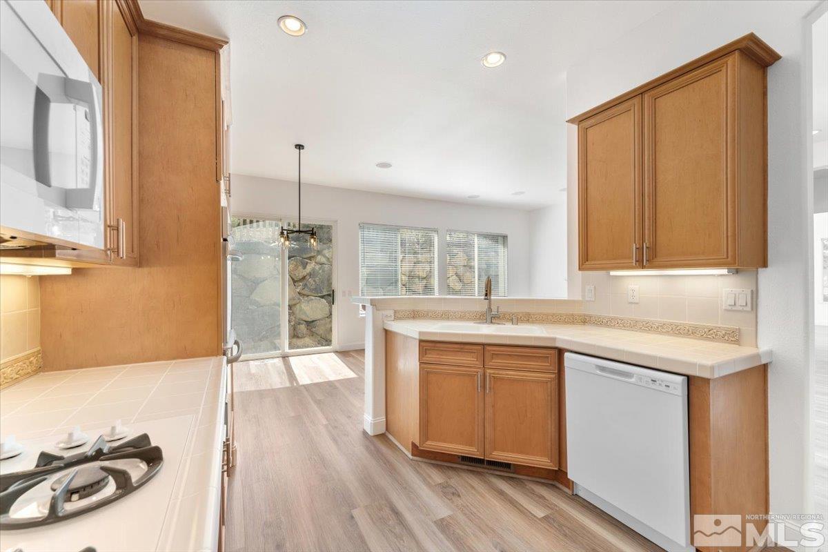 1730 Hunter Creek Road Reno, NV 89519 - Photo 15 of 39 a kitchen with a sink stove and cabinets