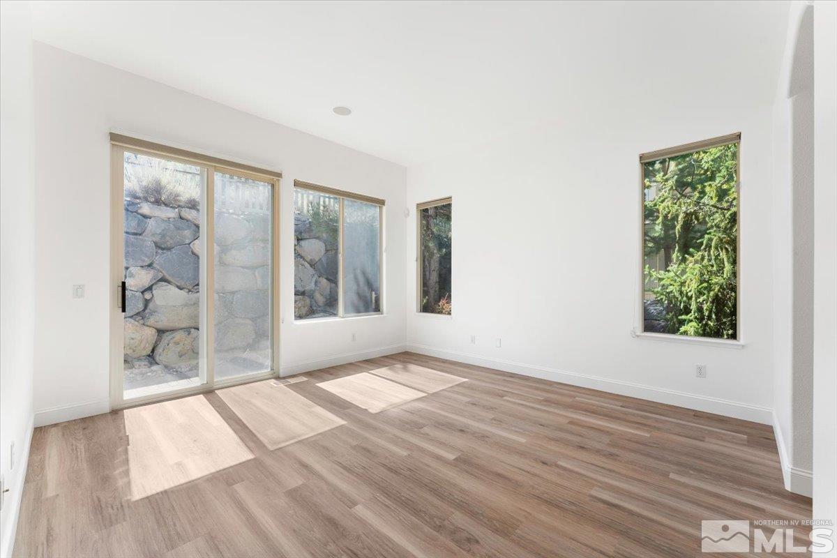 1730 Hunter Creek Road Reno, NV 89519 - Photo 17 of 39 an empty room with wooden floor and windows