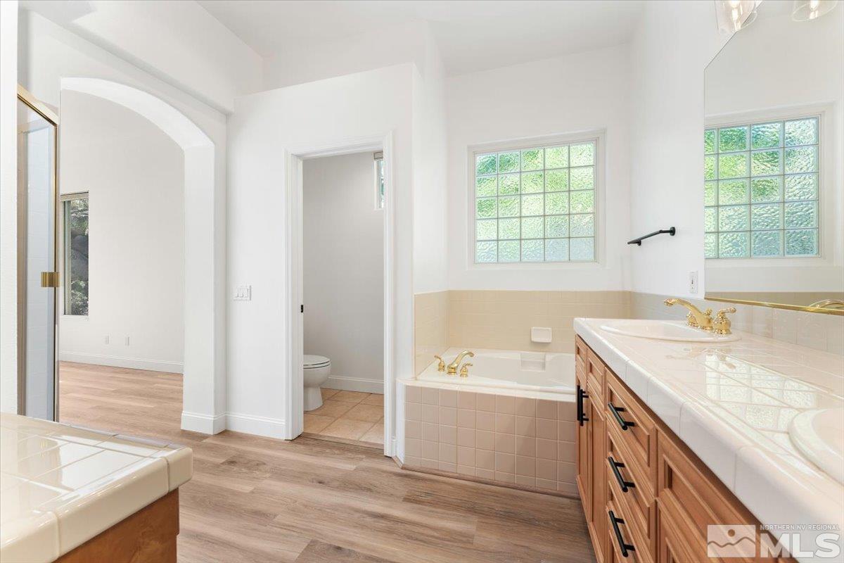 1730 Hunter Creek Road Reno, NV 89519 - Photo 20 of 39 a bathroom with a granite countertop sink and a bathtub