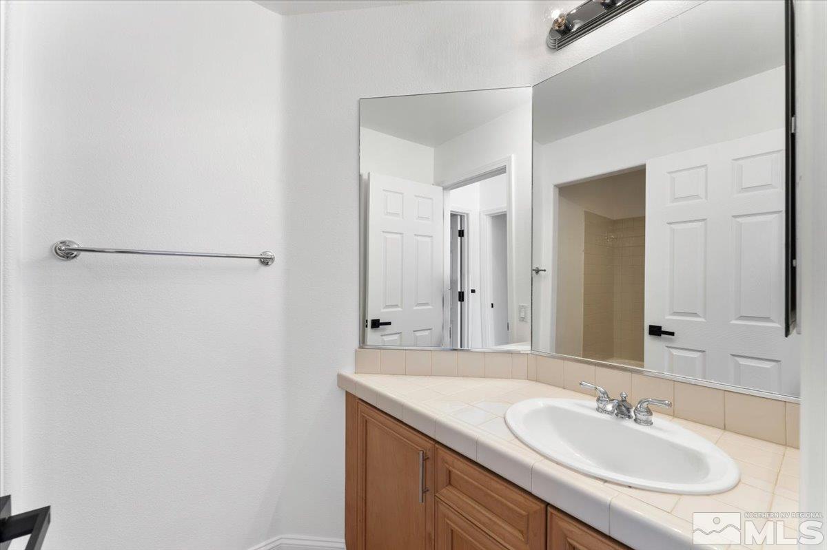 1730 Hunter Creek Road Reno, NV 89519 - Photo 24 of 39 a bathroom with a granite countertop sink and a mirror