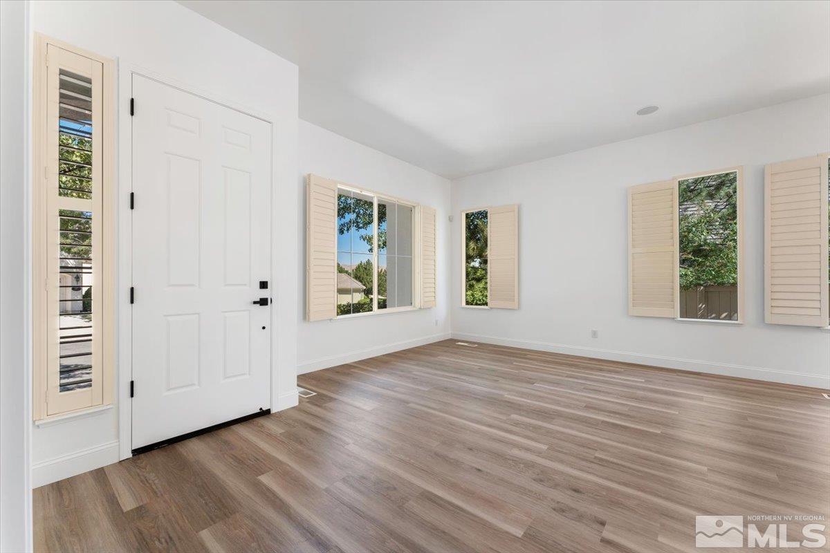 1730 Hunter Creek Road Reno, NV 89519 - Photo 4 of 39 an empty room with wooden floor and windows