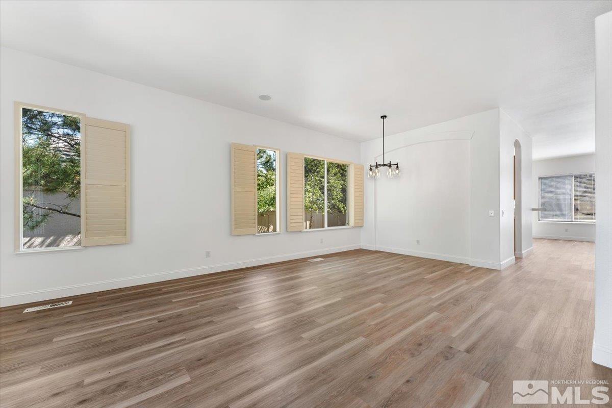 1730 Hunter Creek Road Reno, NV 89519 - Photo 5 of 39 a view of an empty room with wooden floor and a window