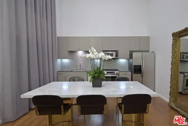 a view of a dining room with furniture and wooden floor