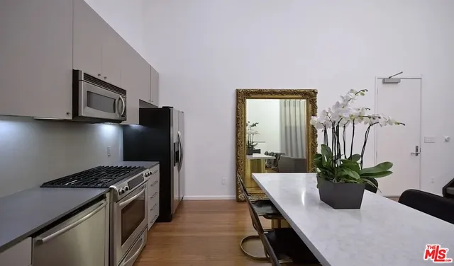 a kitchen with a refrigerator and a stove