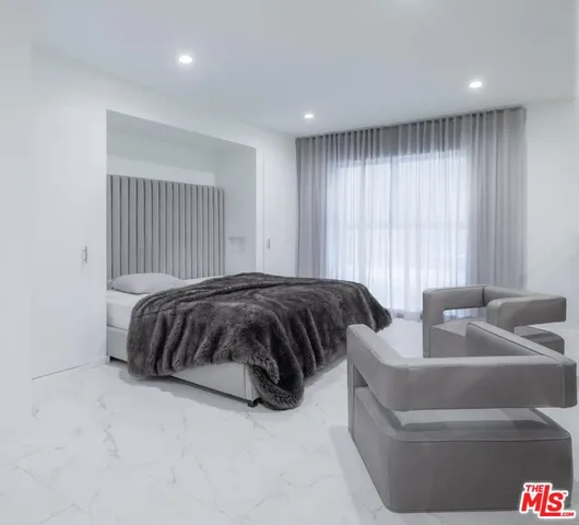 a bedroom with a bed and a couch