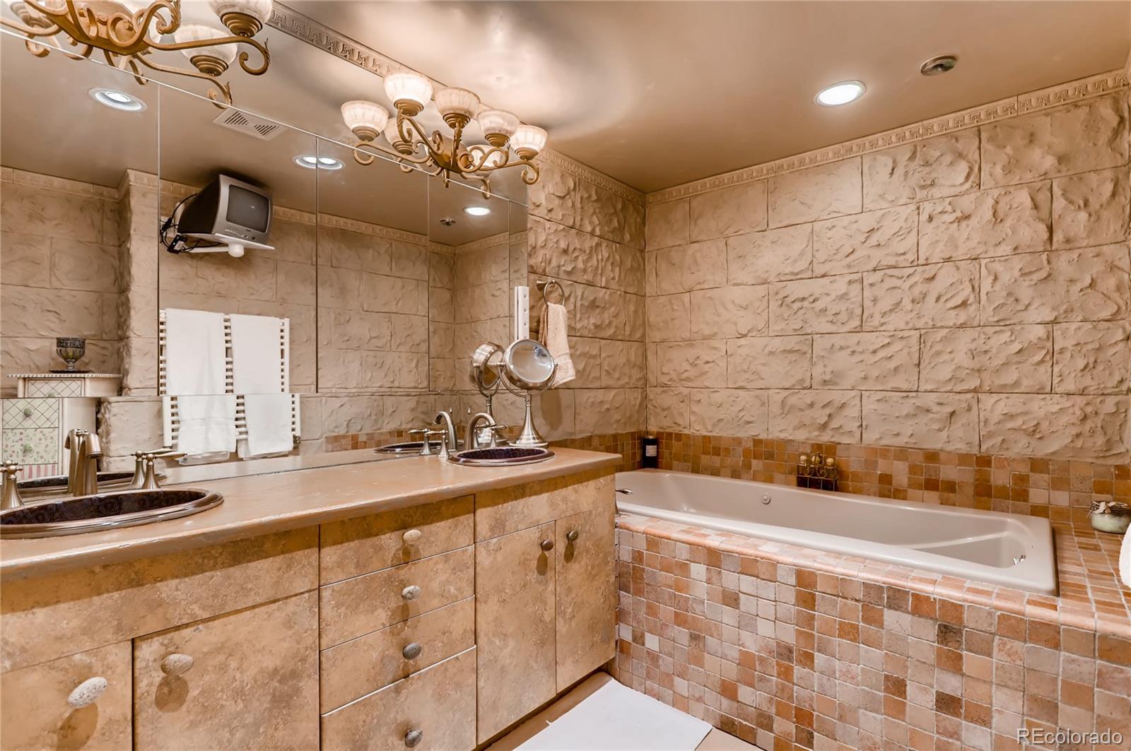 626 Fillmore Street Denver, CO 80206 - Photo 18 of 31 a bathroom with a sink a large mirror and a bathtub