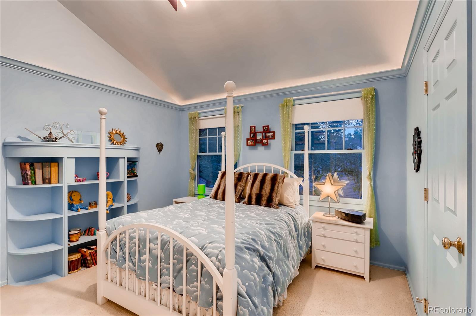 626 Fillmore Street Denver, CO 80206 - Photo 19 of 31 a bedroom with a bed a shelf and book shelf