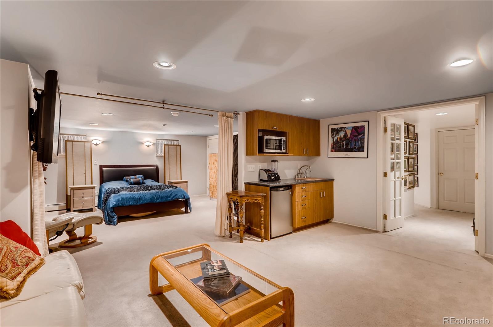 626 Fillmore Street Denver, CO 80206 - Photo 22 of 31 a bedroom with furniture and a flat screen tv