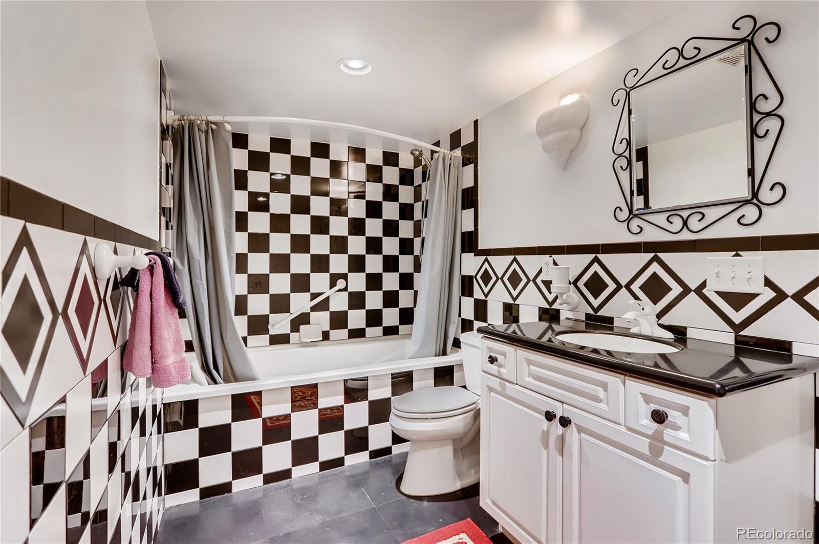 626 Fillmore Street Denver, CO 80206 - Photo 24 of 31 a bathroom with a black and white sink and a black white checkered floor