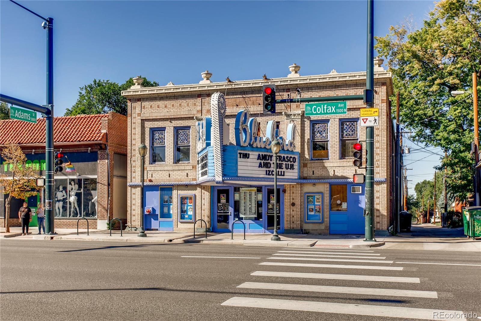 626 Fillmore Street Denver, CO 80206 - Photo 30 of 31 a front view of multi story building with retail shops car parked and traffic signal