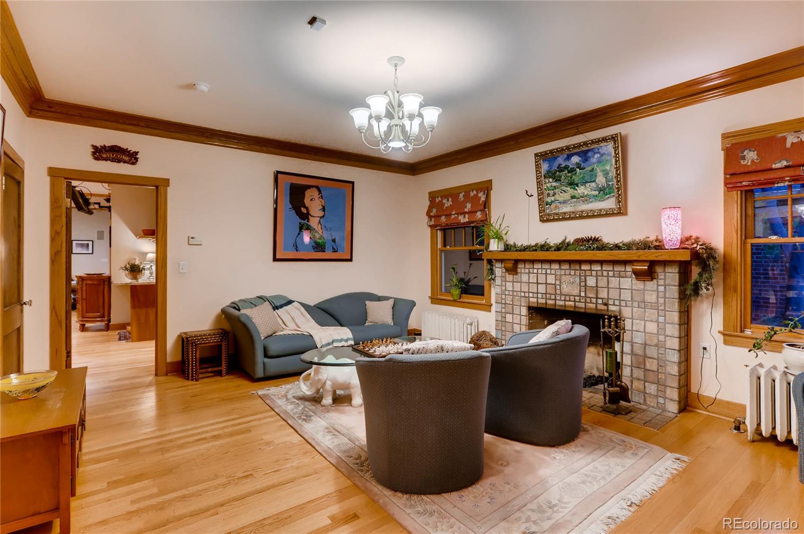 626 Fillmore Street Denver, CO 80206 - Photo 5 of 31 a living room with furniture a fireplace and a flat screen tv