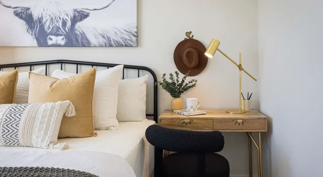 a bedroom with a bed and painting on the wall