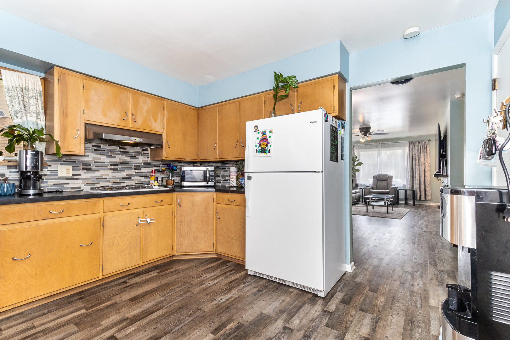 14 South Reed Street Joliet, IL 60436 - Photo 5 of 15 a kitchen with a refrigerator a stove top oven a sink and cabinets