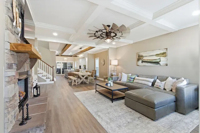 a living room with furniture a fireplace and a flat screen tv