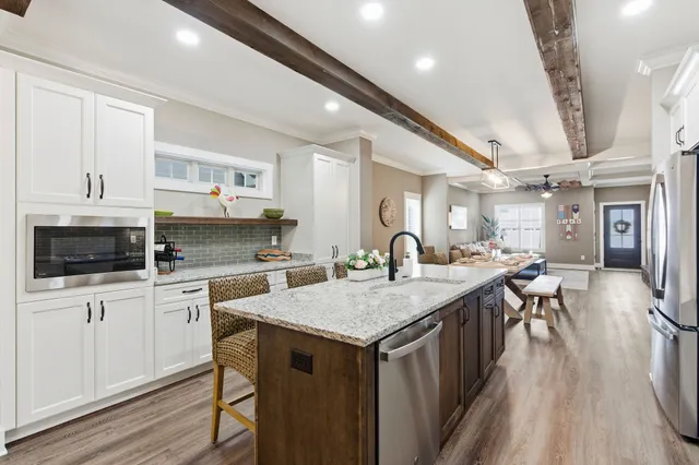 a kitchen with stainless steel appliances granite countertop a stove oven and a refrigerator