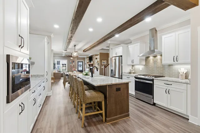 a bathroom with a granite countertop toilet sink and mirror