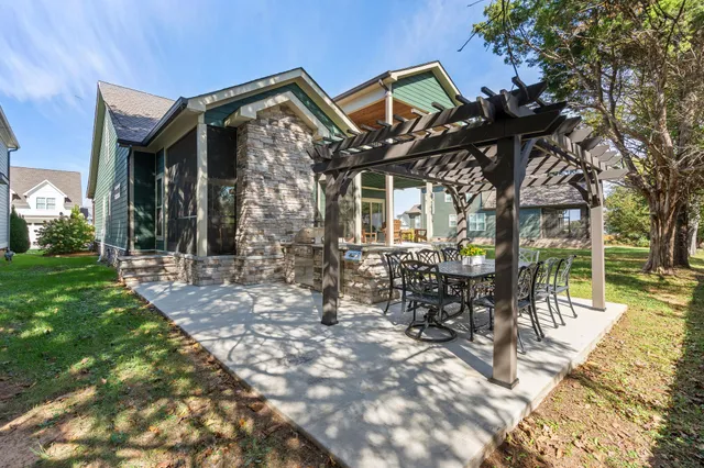 a view of a house with backyard and sitting area