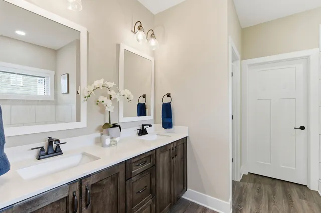 a en suite bathroom with a tub sink and mirror