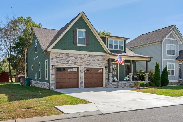 a front view of a house with a yard and garage