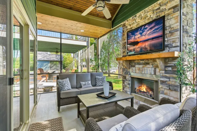 an aerial view of a house with swimming pool lake and mountain view