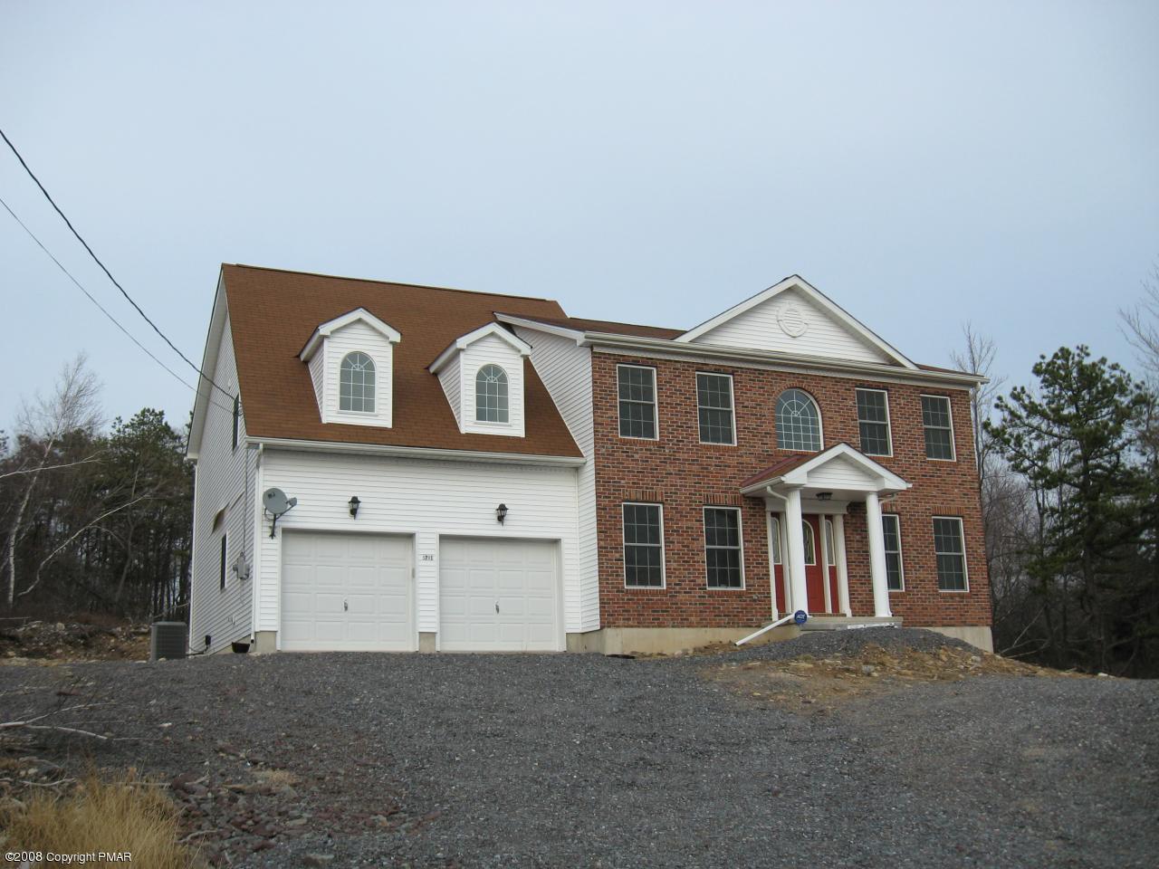 5791 Clover Road Long Pond, PA 18334 - Photo 1 of 8 a front view of a house with a yard and garage