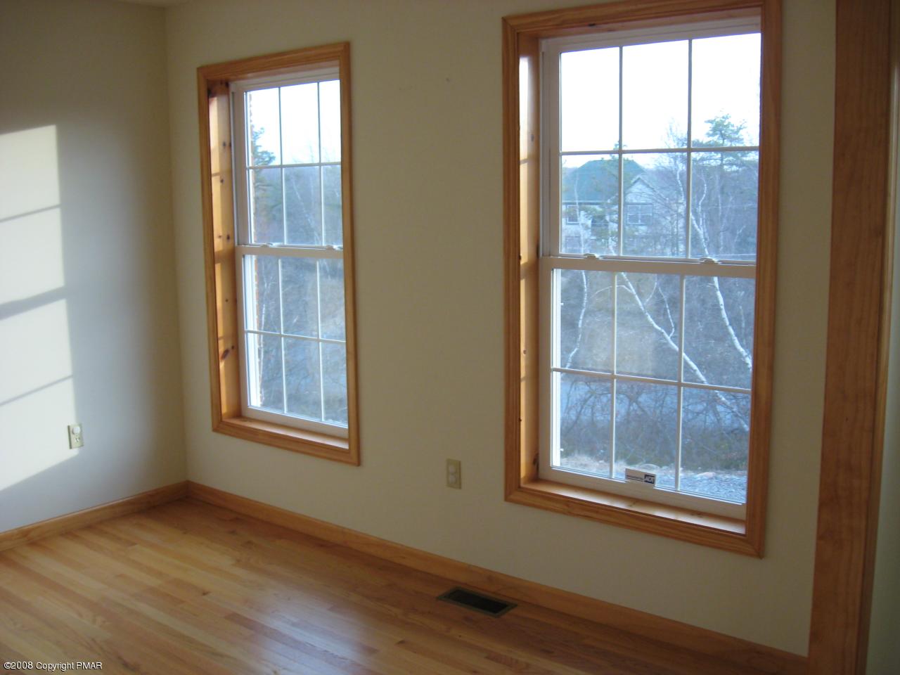 5791 Clover Road Long Pond, PA 18334 - Photo 3 of 8 an empty room with wooden floor and windows