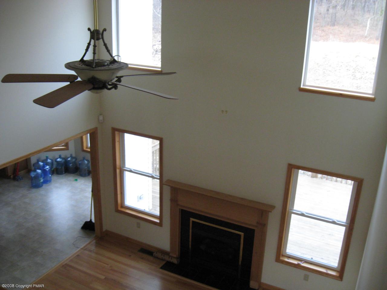 5791 Clover Road Long Pond, PA 18334 - Photo 4 of 8 a view of a livingroom with a window and wooden floor