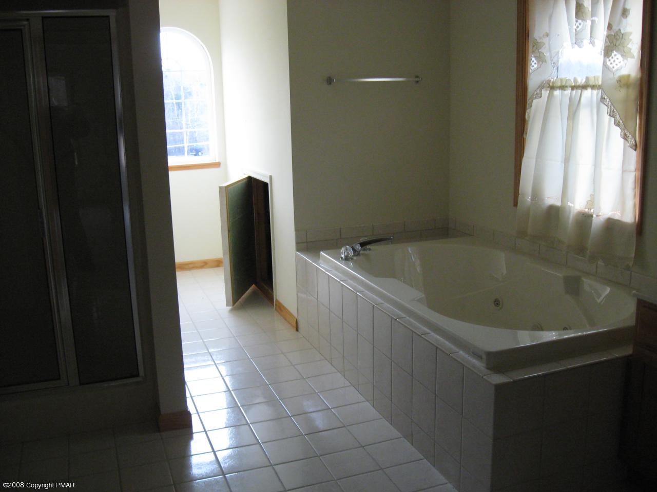 5791 Clover Road Long Pond, PA 18334 - Photo 5 of 8 a bathroom with a bathtub and shower