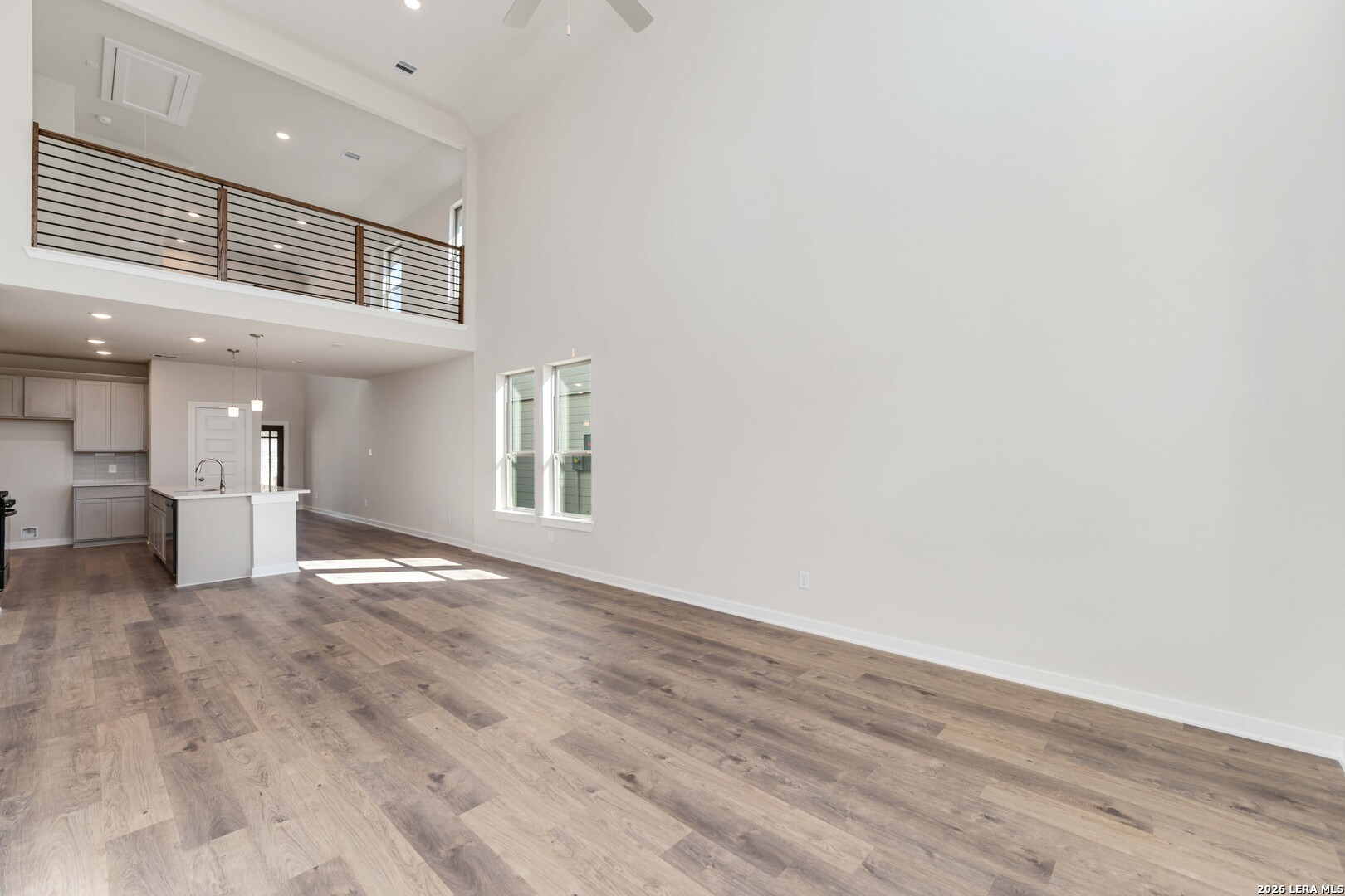 3018 Haffner Road Converse, TX 78109 - Photo 6 of 27 wooden floor in an empty room with a window