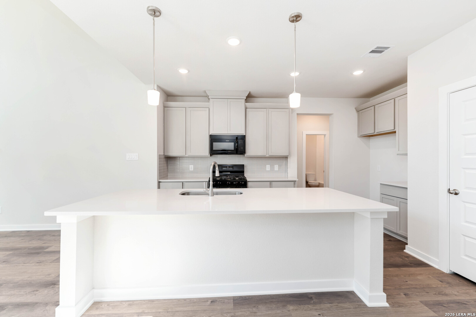 3018 Haffner Road Converse, TX 78109 - Photo 8 of 27 a large kitchen with kitchen island a large counter top stainless steel appliances and cabinets