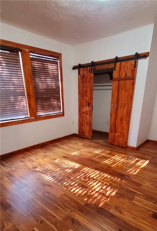 809 Hickey Street Alice, TX 78332 - Photo 8 of 13 a view of an empty room with wooden floor and a window