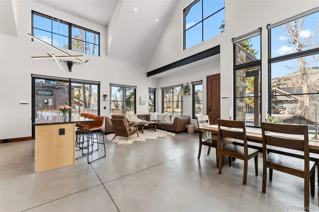 a living room with furniture a large window and chairs