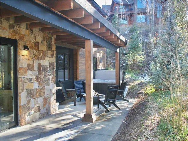 a view of patio with table and chairs and potted plants