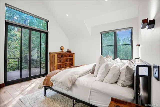 a bedroom with a bed and a large window