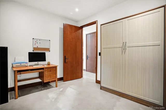a view of a refrigerator in kitchen and white cabinets