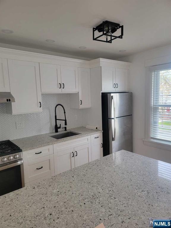139 Union Place, Unit 2 Ridgefield Park, NJ 07660 - Photo 12 of 14 a kitchen with stainless steel appliances granite countertop a refrigerator a sink a stove and white cabinets