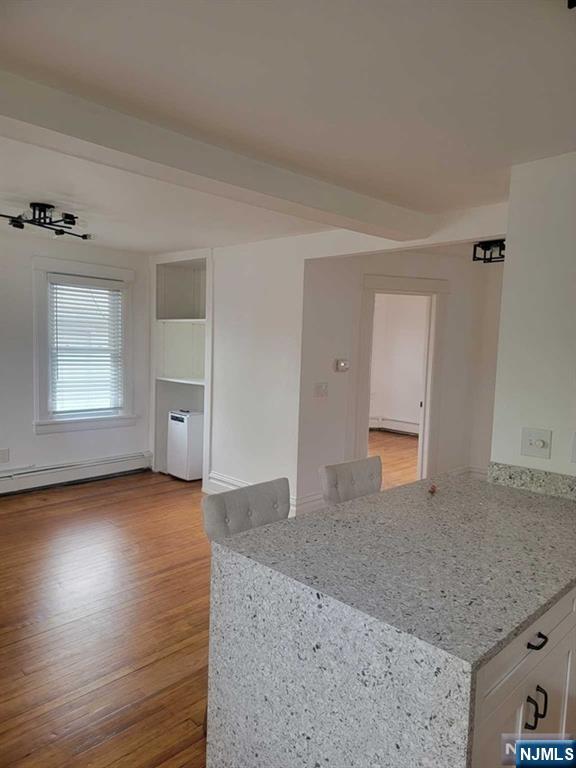 139 Union Place, Unit 2 Ridgefield Park, NJ 07660 - Photo 4 of 14 a view of a livingroom with wooden floor and window