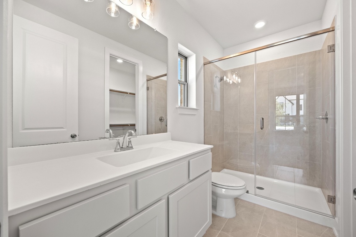 201 Buckaroo Drive Georgetown, TX 78633 - Photo 18 of 36 a bathroom with a sink a toilet and shower