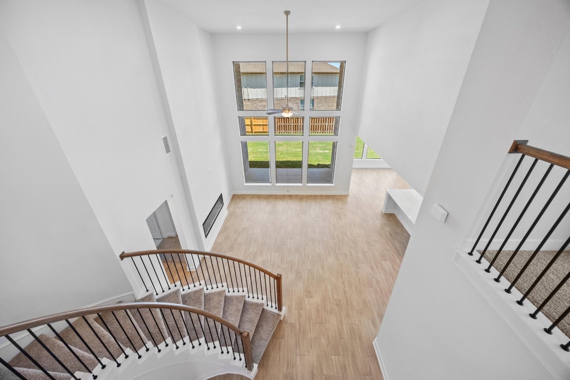 201 Buckaroo Drive Georgetown, TX 78633 - Photo 19 of 36 a view of an empty room with wooden floor and windows