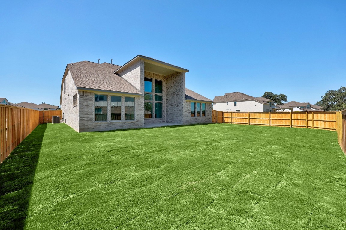 201 Buckaroo Drive Georgetown, TX 78633 - Photo 31 of 36 a view of a house with a backyard and a garden