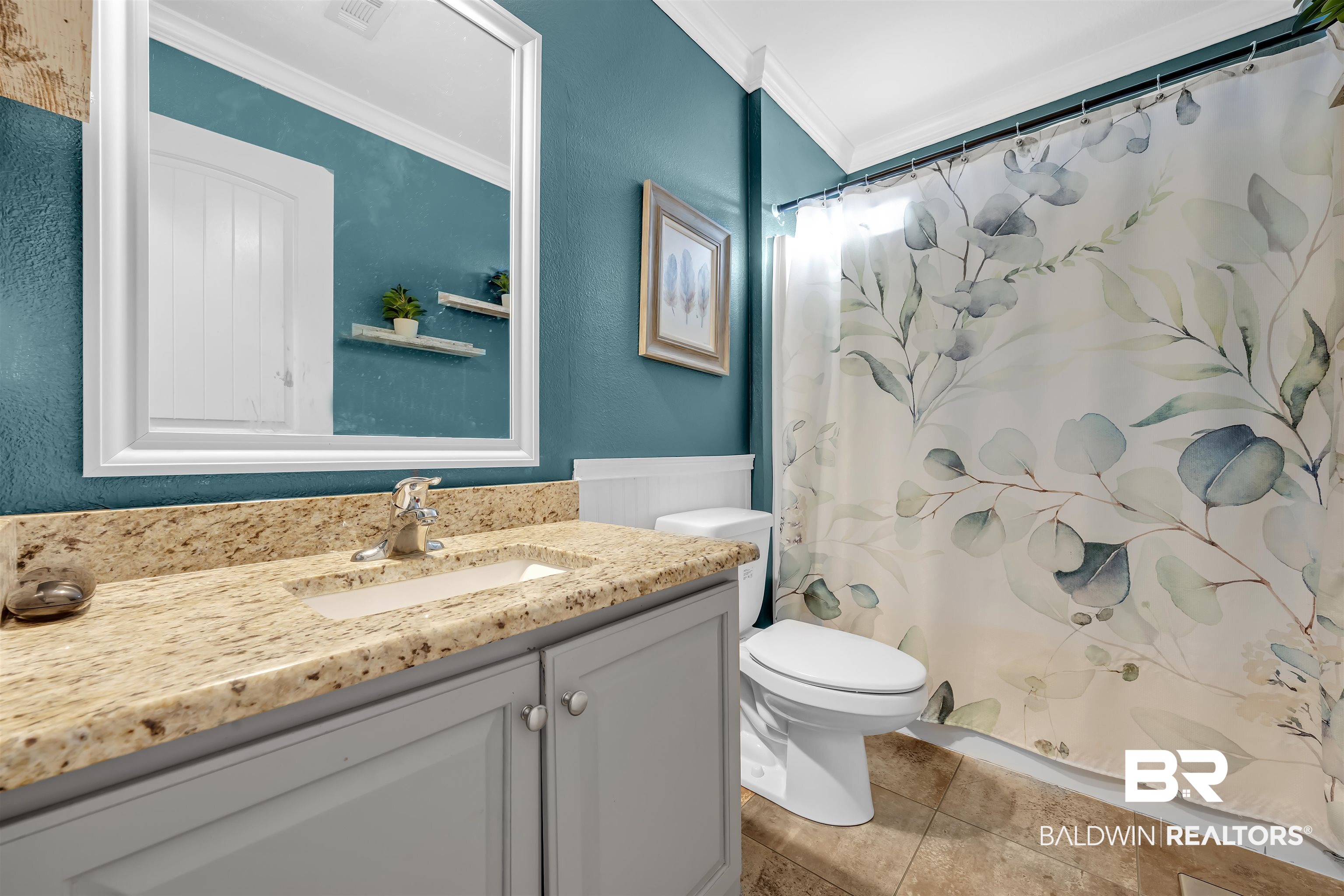 10180 Lyttleton Loop Lillian, AL 36549 - Photo 19 of 37 Bathroom with curtained shower, vanity, ornamental molding, and light tile patterned floors