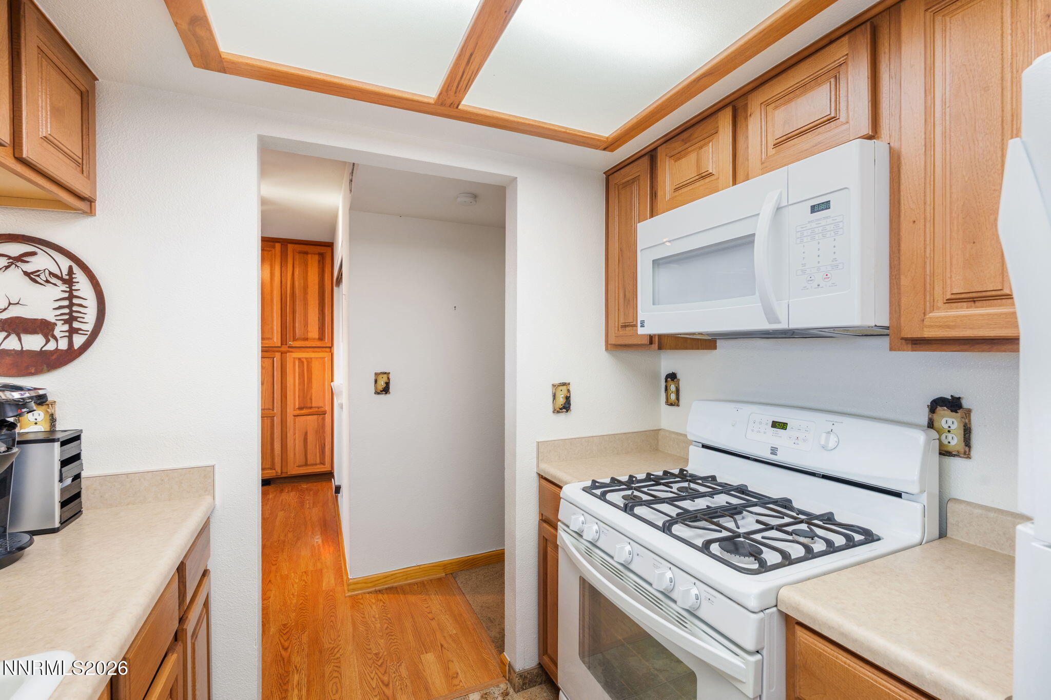 759 Boulder Court, Unit F Stateline, NV 89449 - Photo 10 of 36 a kitchen with stainless steel appliances granite countertop a stove and a microwave