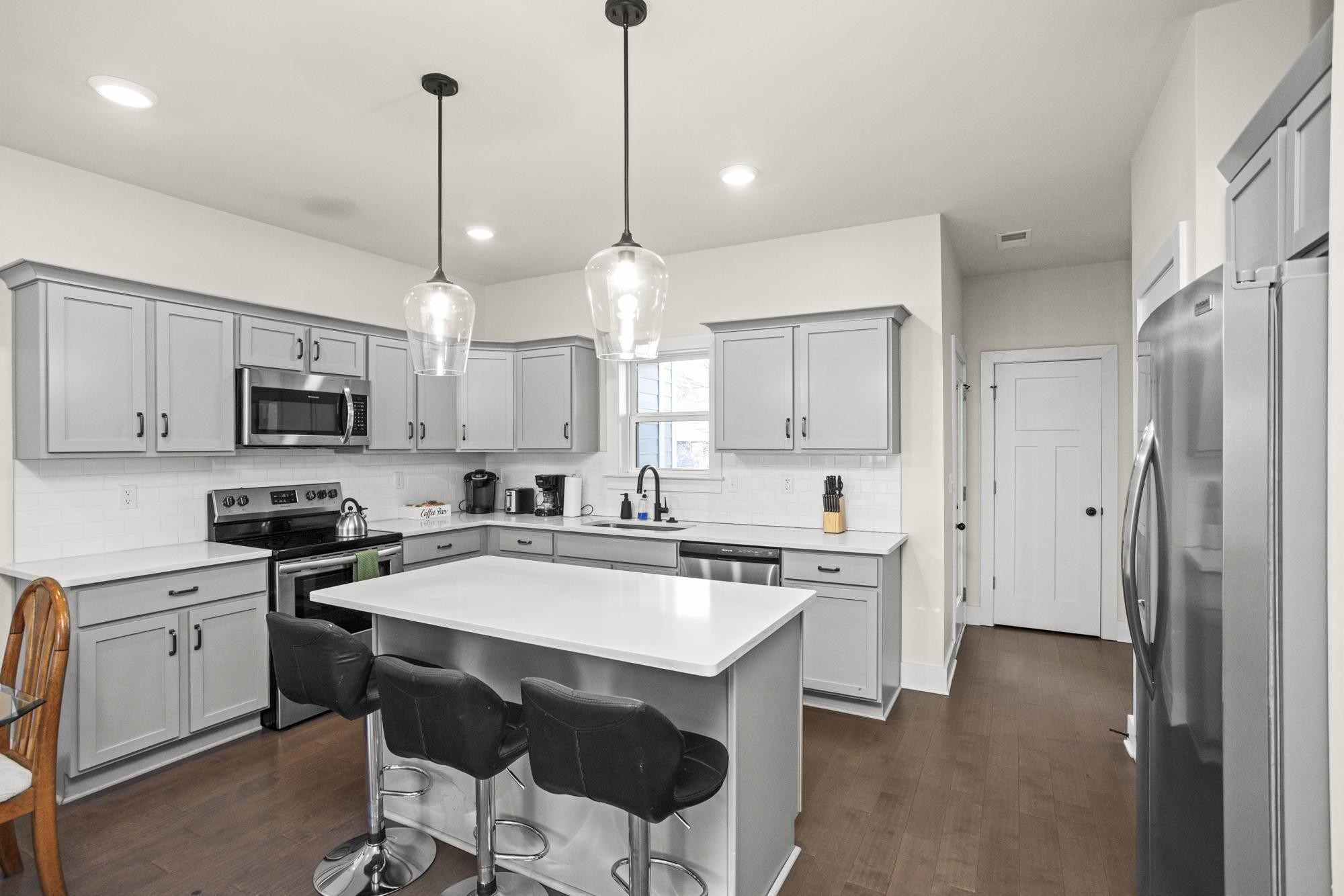 450 Glastonbury Road, Unit 3 Nashville, TN 37217 - Photo 26 of 43 a kitchen with stainless steel appliances granite countertop a stove a sink dishwasher a refrigerator white cabinets and wooden floor
