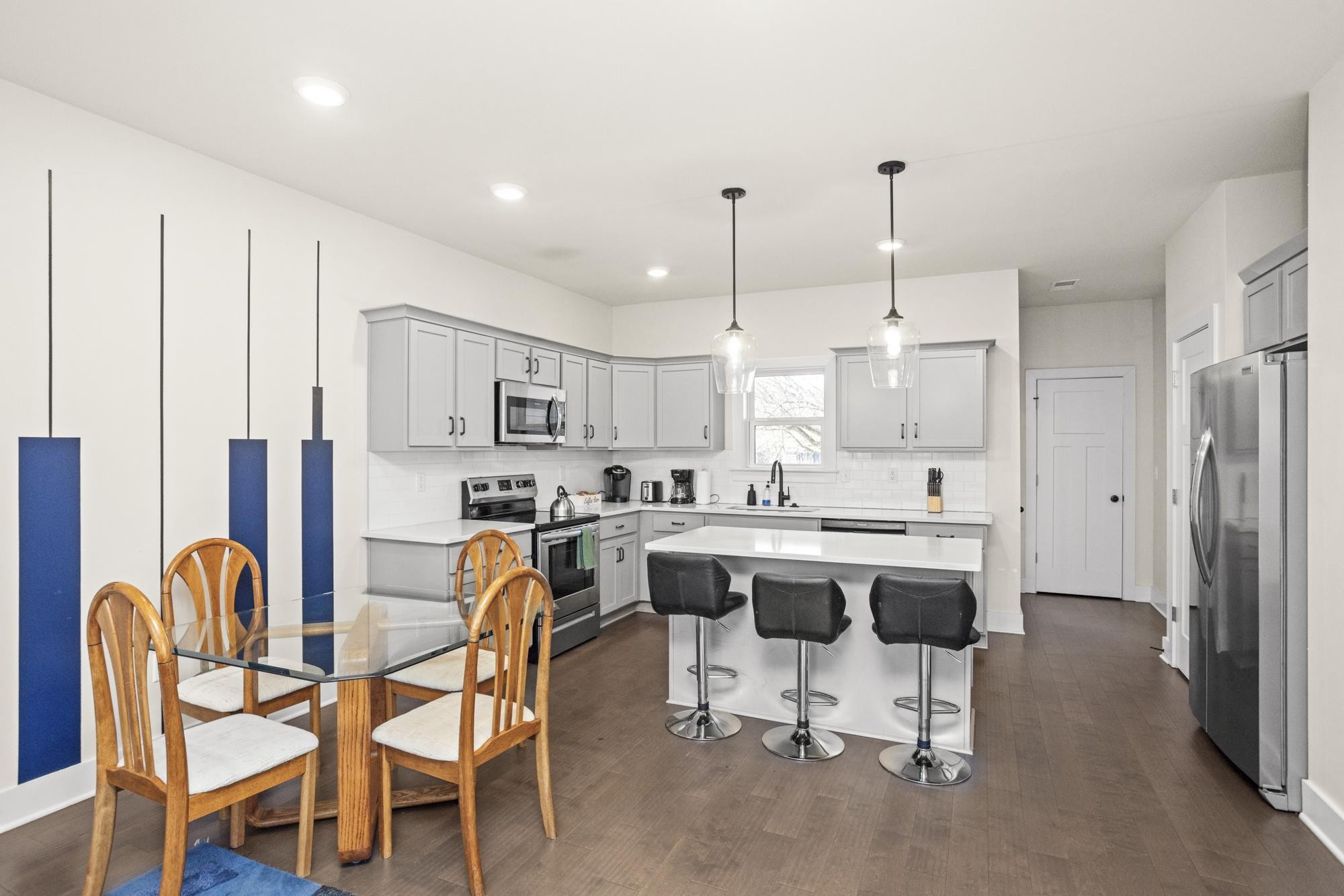 450 Glastonbury Road, Unit 3 Nashville, TN 37217 - Photo 31 of 43 a kitchen with stainless steel appliances kitchen island granite countertop a table chairs sink and cabinets