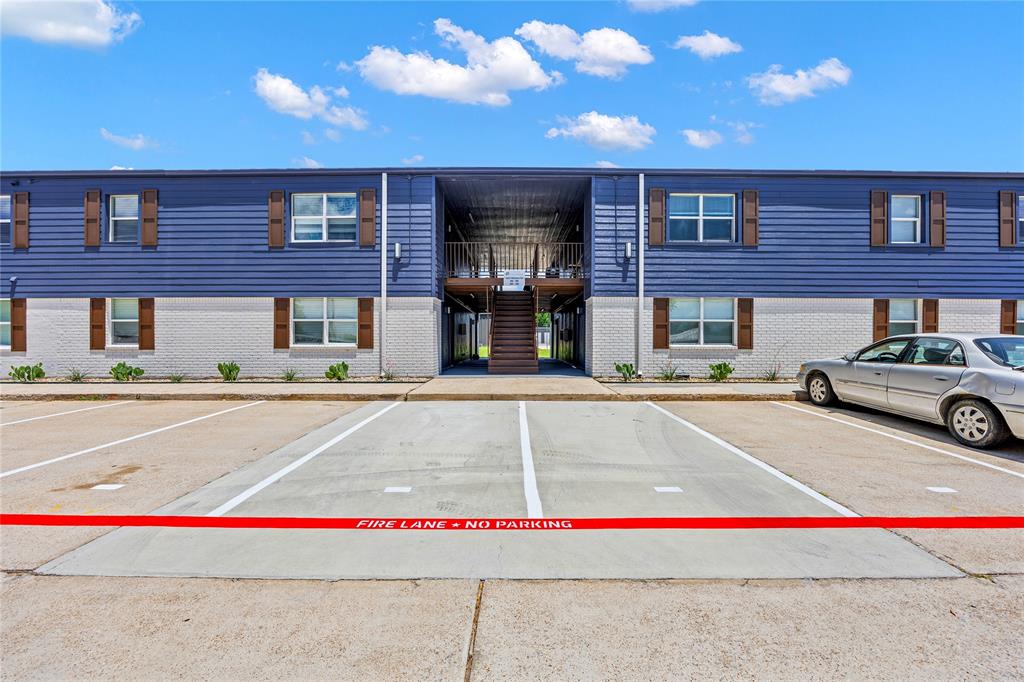 4639 Williams Road, Unit 107 Benbrook, TX 76116 - Photo 9 of 11 View of building exterior featuring uncovered parking and stairs