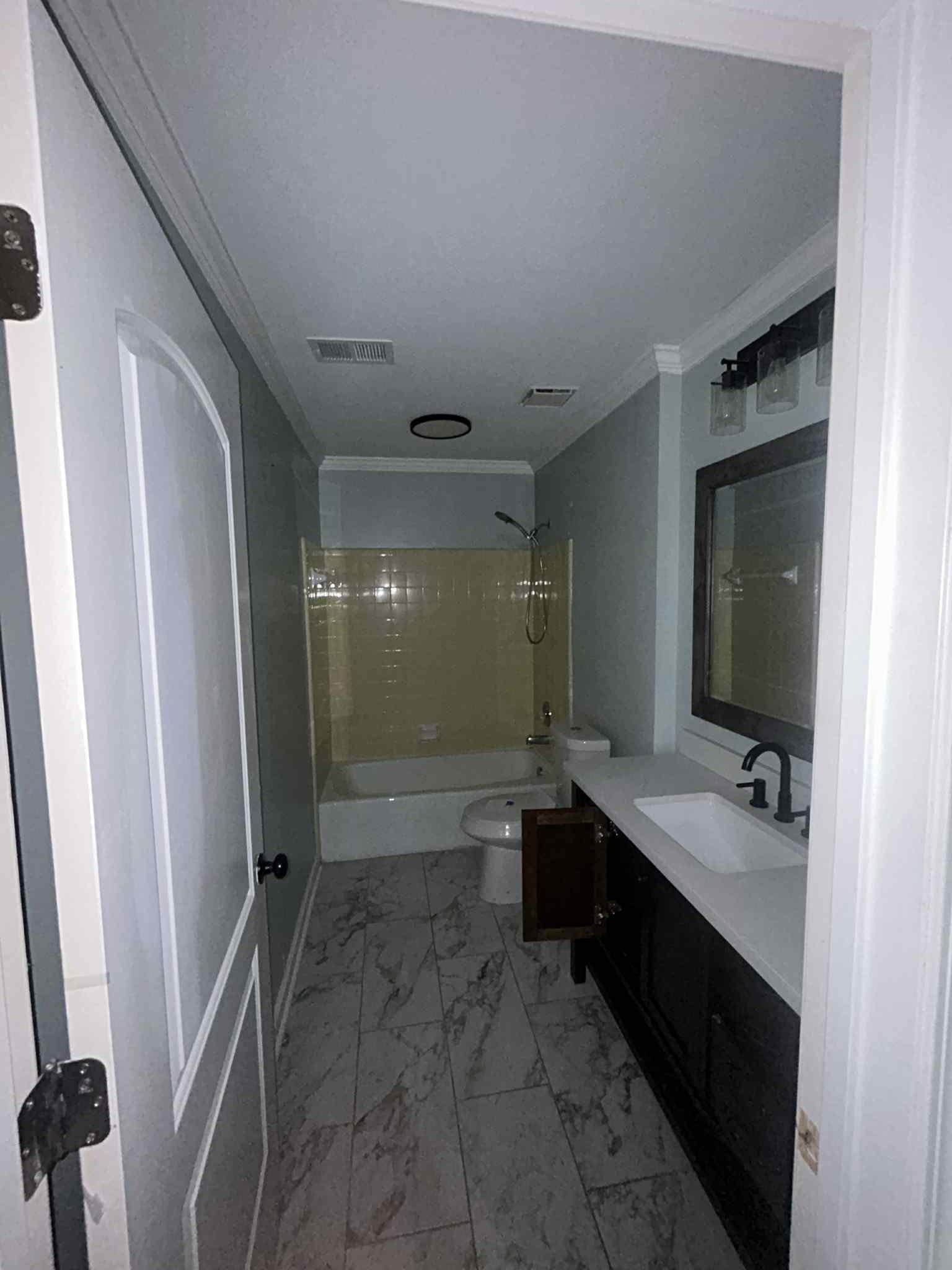 1012 Hunters Point Drive Memphis, TN 38018 - Photo 5 of 10 a bathroom with a double vanity sink toilet mirror and bathtub