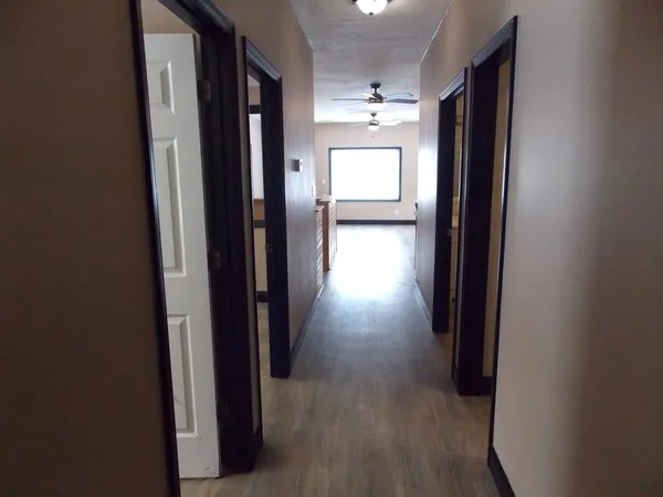 a view of a hallway with wooden floor